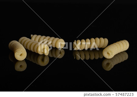 Raw pasta fusilli bucati isolated on black glass 57487223