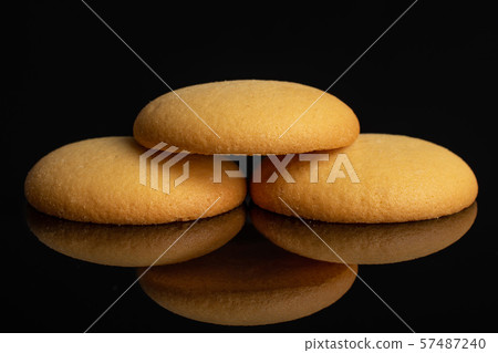 Sweet sponge biscuit isolated on black glass Sweet sponge biscuit isolated on black glass 57487240
