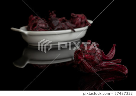 Candied hibiscus isolated on black glass Candied hibiscus isolated on black glass 57487332