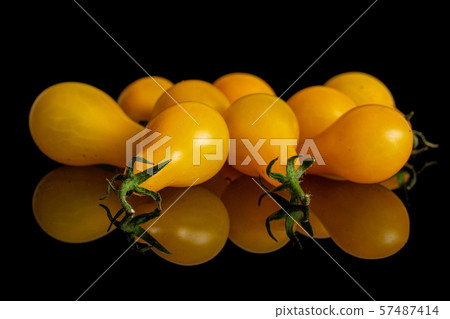 Yellow pear tomato isolated on black glass Yellow pear tomato isolated on black glass 57487414