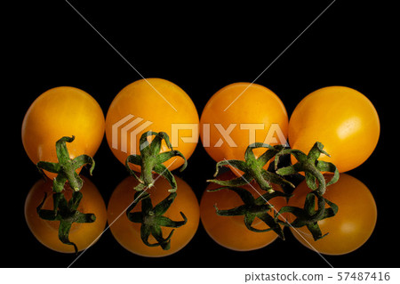 Yellow pear tomato isolated on black glass Yellow pear tomato isolated on black glass 57487416