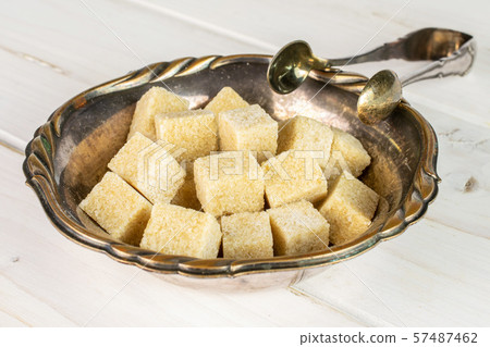 Brown sugar cube on grey wood Brown sugar cube on grey wood 57487462