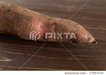 Fresh sweet potato on brown wood Fresh sweet potato on brown wood 57487524