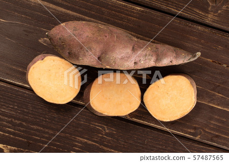 Fresh sweet potato on brown wood Fresh sweet potato on brown wood 57487565