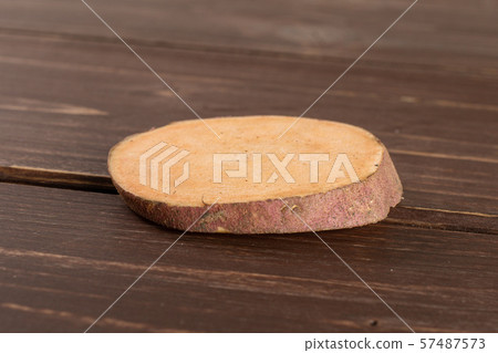 Fresh sweet potato on brown wood Fresh sweet potato on brown wood 57487573