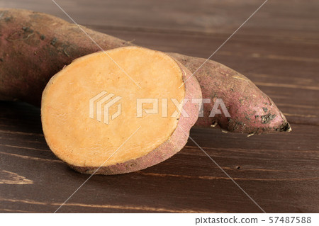 Fresh sweet potato on brown wood Fresh sweet potato on brown wood 57487588