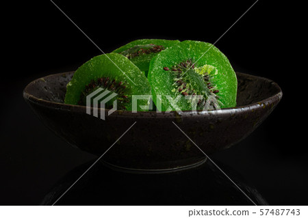 Sweet candied kiwifruit isolated on black glass Sweet candied kiwifruit isolated on black glass 57487743