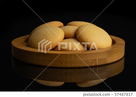Sweet sponge biscuit isolated on black glass Sweet sponge biscuit isolated on black glass 57487817