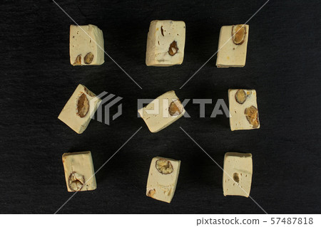 White nougat candy on grey stone White nougat candy on grey stone 57487818