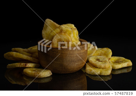 Yellow dry banana isolated on black glass Yellow dry banana isolated on black glass 57487819