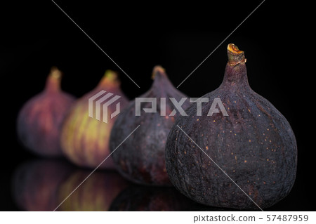 Fresh fig fruit isolated on black glass Fresh fig fruit isolated on black glass 57487959