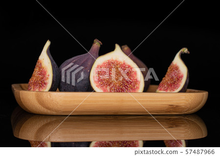 Fresh fig fruit isolated on black glass Fresh fig fruit isolated on black glass 57487966