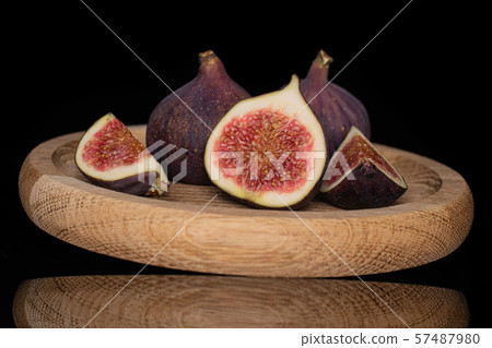 Fresh fig fruit isolated on black glass Fresh fig fruit isolated on black glass 57487980
