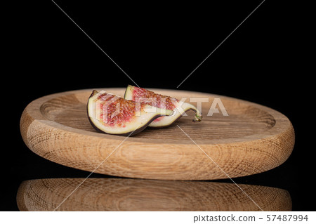 Fresh fig fruit isolated on black glass Fresh fig fruit isolated on black glass 57487994