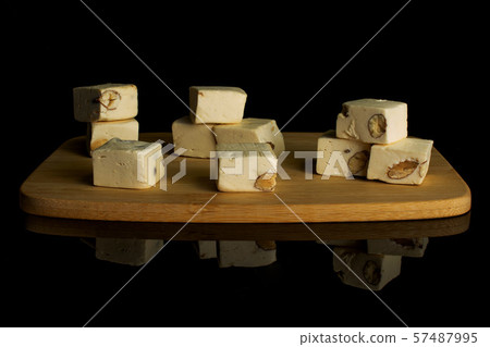 White nougat candy isolated on black glass White nougat candy isolated on black glass 57487995