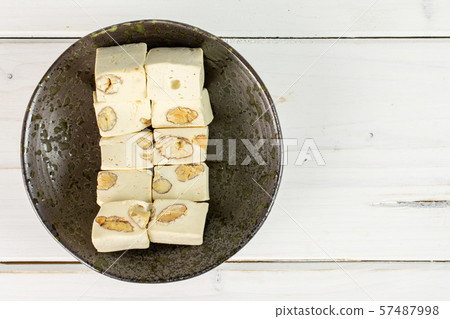 White nougat candy on grey wood White nougat candy on grey wood 57487998