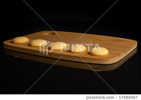 Sweet sponge biscuit isolated on black glass Sweet sponge biscuit isolated on black glass 57488007