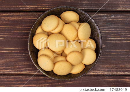 Sweet sponge biscuit on brown wood Sweet sponge biscuit on brown wood 57488049