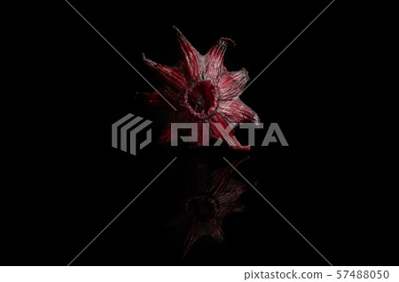 Candied hibiscus isolated on black glass Candied hibiscus isolated on black glass 57488050