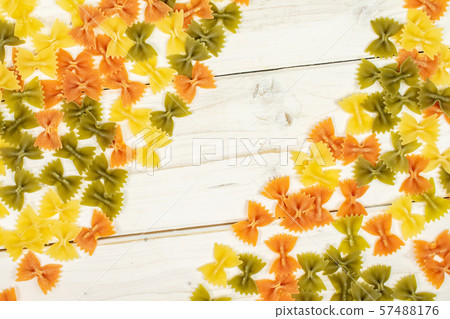 Raw farfalle tricolore on grey wood Raw farfalle tricolore on grey wood 57488176
