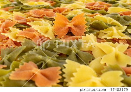 Raw farfalle tricolore on white Raw farfalle tricolore on white 57488179