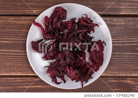 Candied hibiscus on brown wood Candied hibiscus on brown wood 57488240