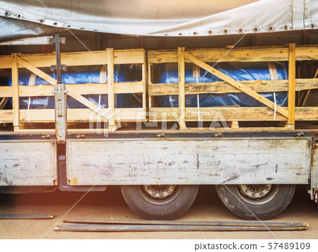 Heat and power equipment transportation with lens flare. Forklift unloads a cargo trailer. 57489109