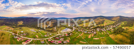 Aerial drone view of urban village Pidbuzh in Carpathians, Ukraine. 180 degrees panoramic landscape Aerial drone view of urban village Pidbuzh in Carpathians, Ukraine. 180 degrees panoramic landscape 57490057