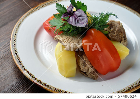 Boiled meat with a side dish and vegetables . restaurant menu Boiled meat with a side dish and vegetables . restaurant menu 57490624
