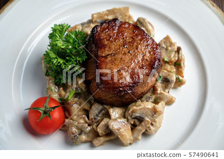 Meat medallion with mushrooms. restaurant menu 57490641