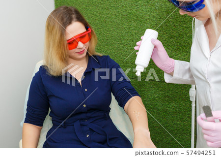 A young woman is preparing for laser hair removal. A young woman is preparing for laser hair removal. 57494251