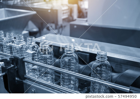 The PET bottles on the conveyor belt . 57494950