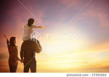 happy family standing and watching the sunset happy family standing and watching the sunset 57495069