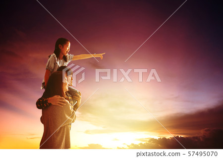 asian family standing and watching the sunset 57495070