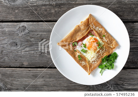 Breton crepe with egg on a white plate 57495236