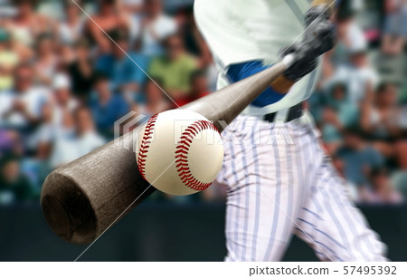 Baseball player hitting ball with bat in close up 57495392