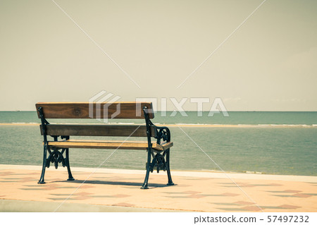 Blue sea,long wood chairs at the tropical beach on Blue sea,long wood chairs at the tropical beach on 57497232