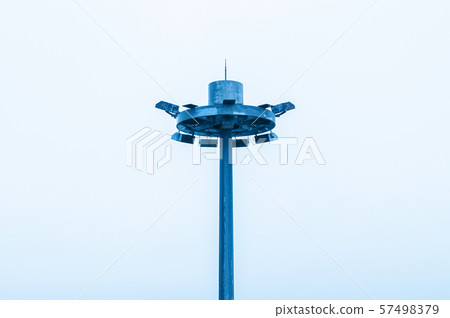 Spotlight pole with pale white sky background Spotlight pole with pale white sky background 57498379