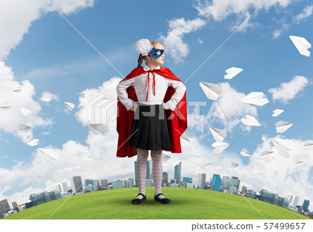 Girl power concept with cute kid guardian against cityscape background Girl power concept with cute kid guardian against cityscape background 57499657