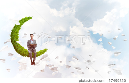 Young businessman or student studying the science and paper planes fly around Young businessman or student studying the science and paper planes fly around 57499830