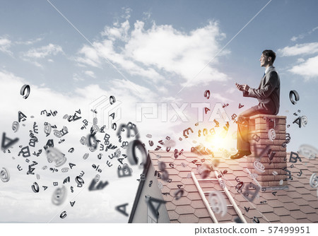 Man on brick roof working with smartphone and symbols flying aro Man on brick roof working with smartphone and symbols flying aro 57499951