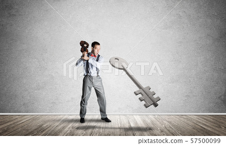 Breaking through access concept with man in room crashing concrete key 57500099
