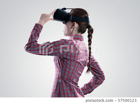 Girl in mask experiencing virtual reality as new entertainment device 57500123