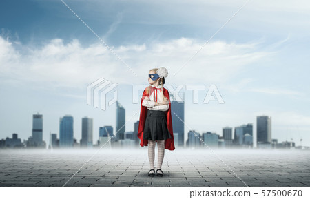 Girl power concept with cute kid guardian against cityscape background . Mixed media Girl power concept with cute kid guardian against cityscape background . Mixed media 57500670