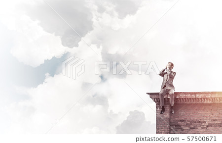 Young man on building edge do not want to see anything Young man on building edge do not want to see anything 57500671