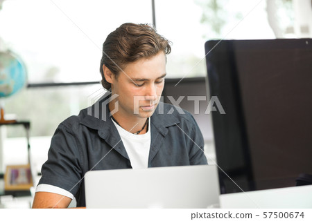 Handsome guy at computer work Handsome guy at computer work 57500674