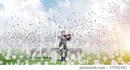 Handsome violinist in park on wooden bench play his melody 57501402