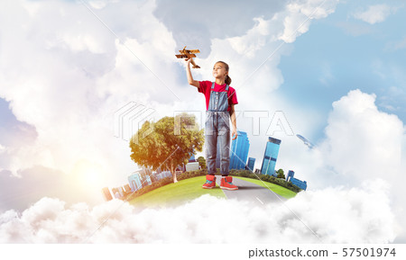 Concept of careless happy childhood with girl dreaming to become pilot Concept of careless happy childhood with girl dreaming to become pilot 57501974