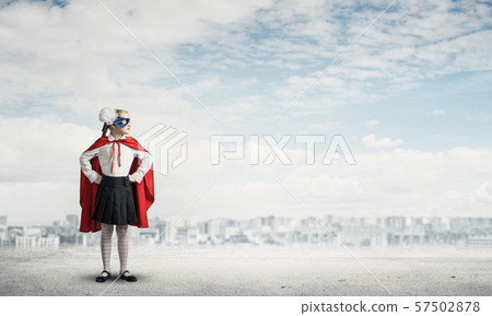 Girl power concept with cute kid guardian against cloudscape background . Mixed media Girl power concept with cute kid guardian against cloudscape background . Mixed media 57502878