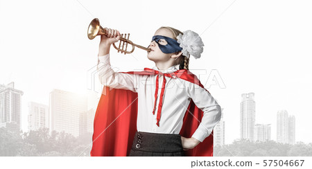 Girl power concept with cute kid guardian against cityscape background 57504667